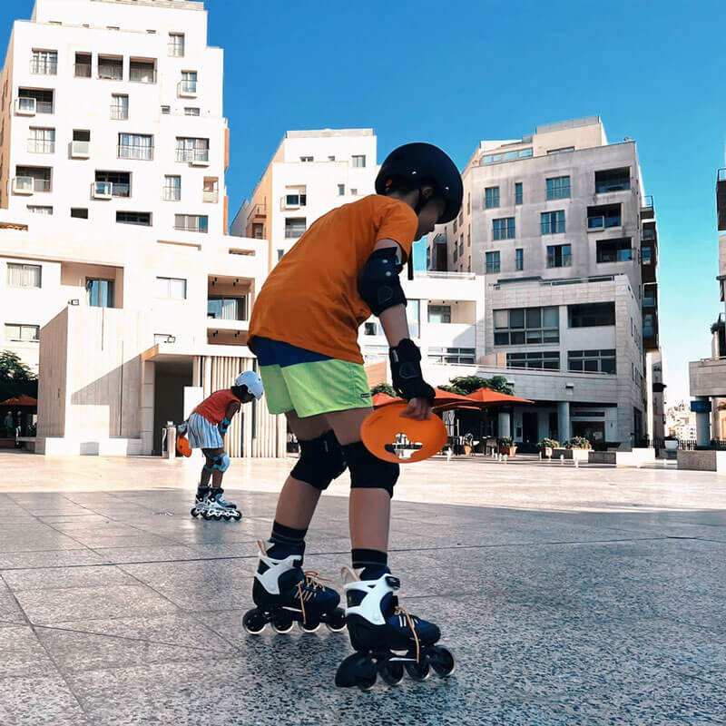 Kid with skates holds cones